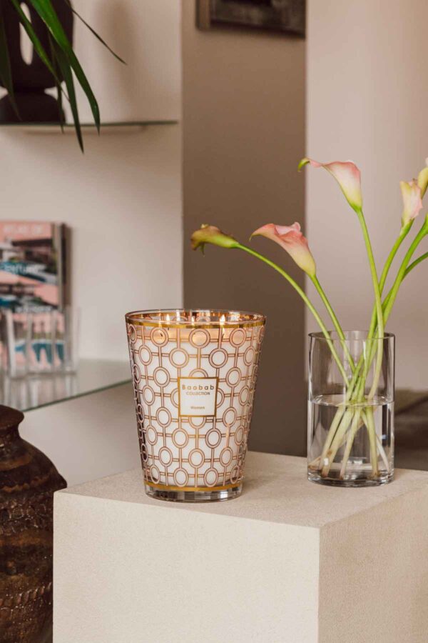 Modern interior setting with lit Baobab Women Candle Max 35 in delicately printed glass with 24-carat yellow gold | Kneen & Co