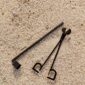 Textured sand environment with Baobab Collection candle snuffer and wick trimmer in black matte metal | Kneen & Co