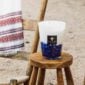 Baobab Feathers Touareg Scented Candle Max 16 | Kneen & Co Lifestyle photo on beach.