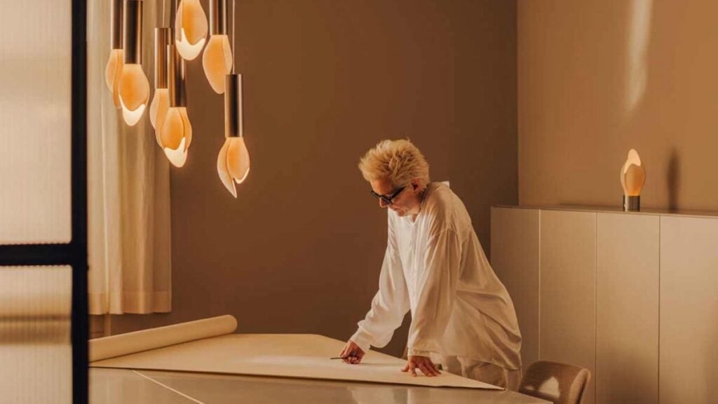 Stefanie Hering sketching a porcelain design at her studio worktable