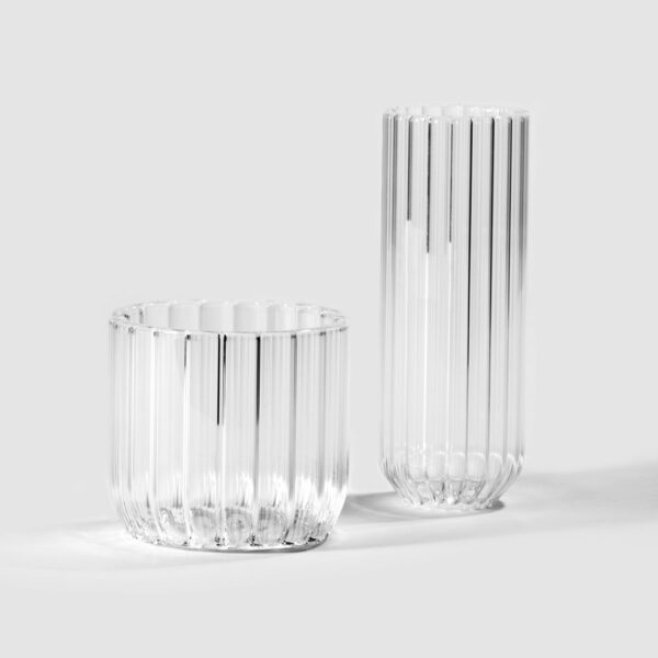 Minimalist light grey studio background with Fferrone Dearborn glasses, featuring the Wine Glass and Champagne Flute in fluted borosilicate glass | Kneen & Co