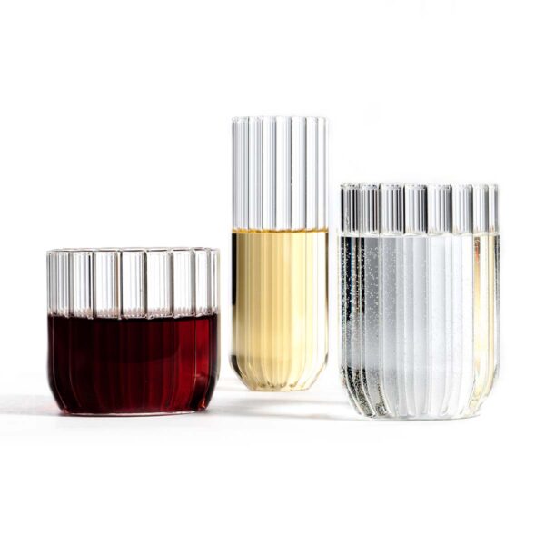 Minimalist white studio background with a trio of Fferrone Dearborn glasses in fluted borosilicate glass, featuring the Wine, Champagne, and Water glasses | Kneen & Co