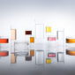 Reflective studio surface with Fferrone Revolution Glassware in borosilicate glass with multi-colored liquid variants | Kneen & Co