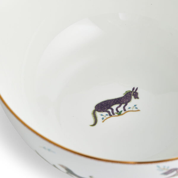 701587237383-Wedgwood-Mythical-Creatures-Salad-Bowl-25pt8cm-10pt2in-detail3-1200x1200-100KB Close-up studio shot with Wedgwood Mythical Creatures salad bowl in fine bone china featuring whimsical animal illustrations and gold rim detailing | Kneen & Co