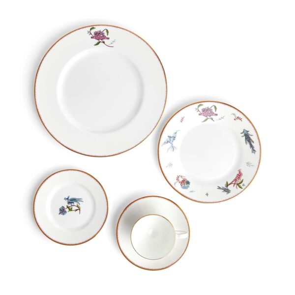701587253116-Wedgwood-Mythical-Creatures-5-Piece-Place-Setting-BXD-1x27cm-Plate-1x-20cm-Plate-1x15cm-Plate-1xTeacup+Saucer-Leigh-angle-1200x1200-100KB Close-up studio shot with Wedgwood Kit Kemp Mythical Creatures 5-piece Dinnerware Set in fine bone china featuring whimsical animal illustrations and gold rim detailing | Kneen & Co