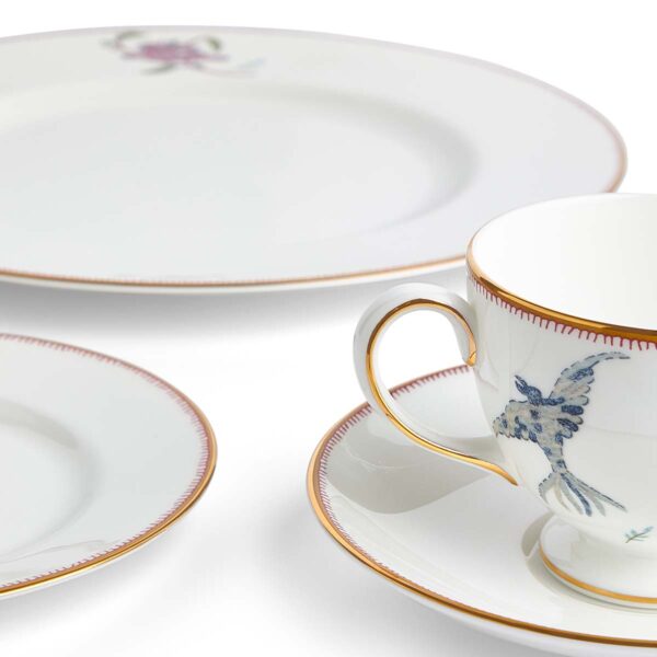 701587253116-Wedgwood-Mythical-Creatures-5-Piece-Place-Setting-BXD-1x27cm-Plate-1x-20cm-Plate-1x15cm-Plate-1xTeacup+Saucer-Leigh-detail-1200x1200-100KB Close-up studio shot with Wedgwood Kit Kemp Mythical Creatures 5-piece Dinnerware Set in fine bone china featuring whimsical animal illustrations and gold rim detailing | Kneen & Co