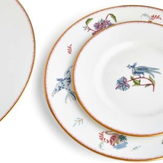 701587253116-Wedgwood-Mythical-Creatures-5-Piece-Place-Setting-BXD-1x27cm-Plate-1x-20cm-Plate-1x15cm-Plate-1xTeacup+Saucer-Leigh-detail2-1200×1200-100KB Close-up studio shot with Wedgwood Kit Kemp Mythical Creatures 5-piece Dinnerware Set in fine bone china featuring whimsical animal illustrations and gold rim detailing | Kneen & Co