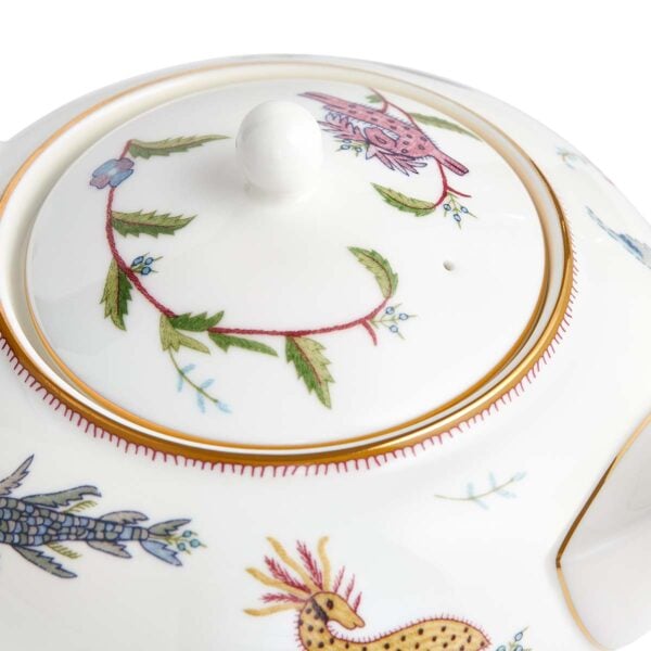 701587253123-Wedgwood-Mythical-Creatures-Large-Sized-Teapot-BXD-detail2-1200x1200-100KB Close-up studio shot with Wedgwood Kit Kemp Mythical Creatures Teapot in fine bone china featuring whimsical animal illustrations and gold rim detailing | Kneen & Co