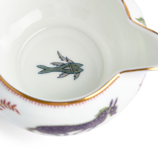 701587253147-Wedgwood-Mythical-Creatures-Large-Sized-Cream-BXD-detail3-1200x1200-100KB Close-up studio shot with Wedgwood Kit Kemp Mythical Creatures Creamer in fine bone china featuring whimsical animal illustrations and gold rim detailing | Kneen & Co