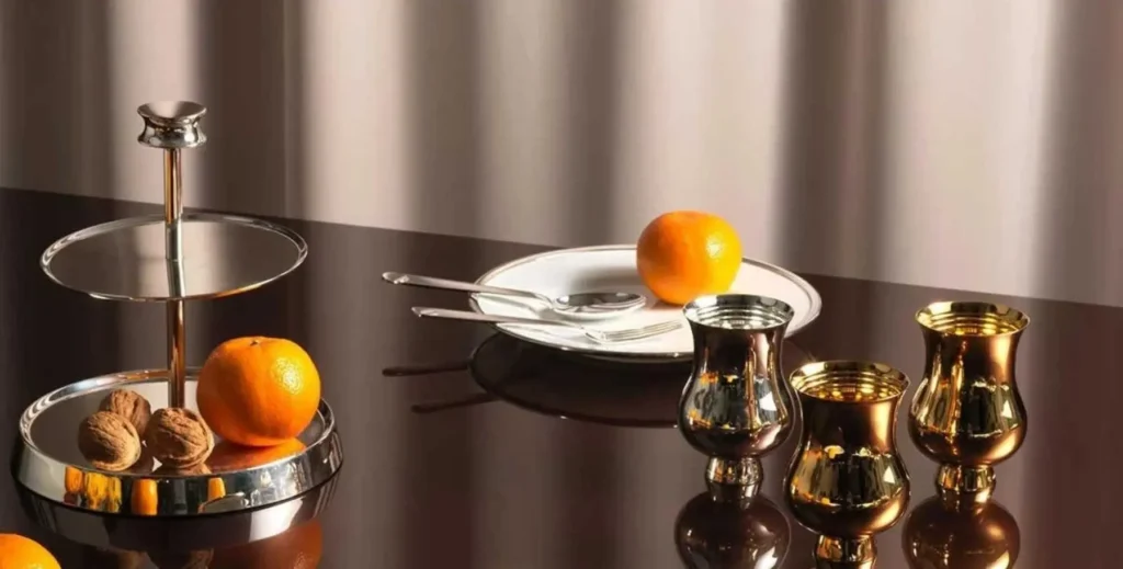 Puiforcat silver table setting with champagne bucket, tumblers, and tiered serving stand