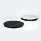 Minimalist studio display with Fferrone Doppio Round Serving Tray Marble in honed Nero Marquina and Carrara marble showing the reversible black and white variants | Kneen & Co