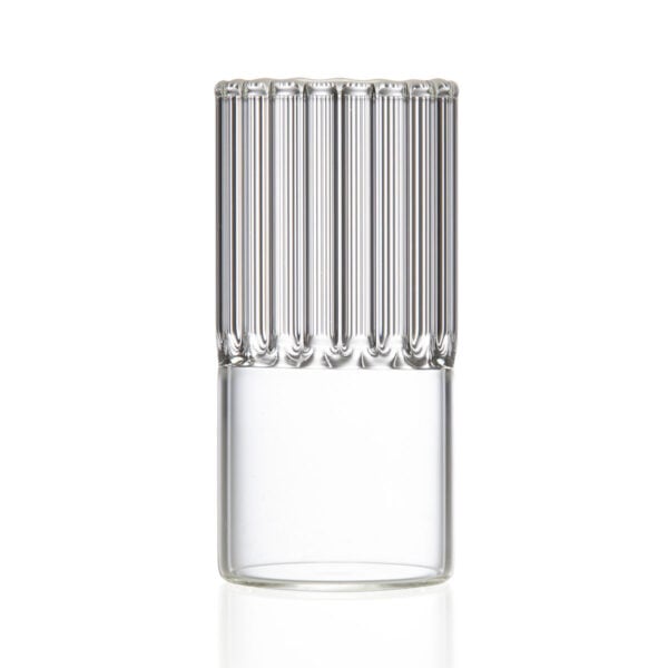 Minimalist studio setting with a dark beverage in a Fferrone Flight Espresso / Liqueur Glass made of borosilicate glass highlighting the small-scale fluted design | Kneen & Co