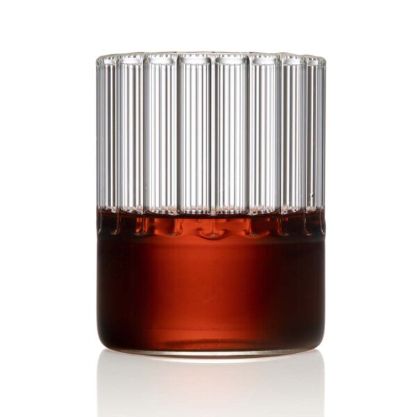 Minimalist studio setting with a clear Fferrone Flight Tumbler in borosilicate glass showcasing the collection's signature handcrafted interior fluting | Kneen & Co