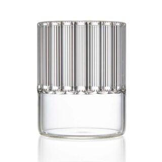 Minimalist studio setting with a clear Fferrone Flight Tumbler in borosilicate glass showcasing the collection's signature handcrafted interior fluting | Kneen & Co