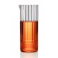 Minimalist studio setting with an amber-toned beverage in a Fferrone Flight Carafe made of borosilicate glass featuring a tall fluted cylindrical design | Kneen & Co