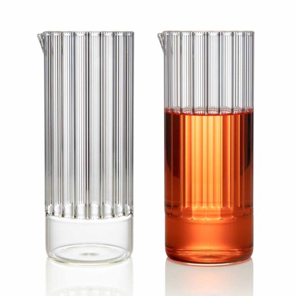 FERRONE-FlightCarafe-190610-FF-0031-pairing-1200x1200-100KB Minimalist studio pairing of a clear and an amber-filled Fferrone Flight Carafe in borosilicate glass showcasing the vertical fluted texture | Kneen & Co