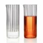 Minimalist studio pairing of a clear and an amber-filled Fferrone Flight Carafe in borosilicate glass showcasing the vertical fluted texture | Kneen & Co