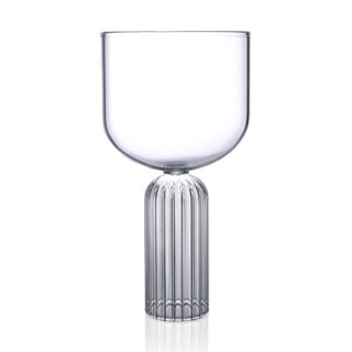 Minimalist studio display of a Fferrone May Large Glass in fluted borosilicate glass featuring a wide smooth bowl and a ribbed cylindrical pedestal base | Kneen & Co