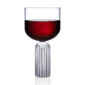 Minimalist studio display of a Fferrone May Large Glass in fluted borosilicate glass filled with red wine featuring a wide smooth bowl and a ribbed cylindrical pedestal bas | Kneen & Co