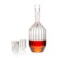 Minimalist studio setting with an amber-toned spirit in a Fferrone Margot Decanter and Mini Glasses in borosilicate glass showcasing the collection's signature fluted texture | Kneen & Co