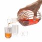 Lifestyle studio setting with a hand pouring spirits from a Fferrone Margot Decanter into Margot Mini Glasses in borosilicate glass highlighting the collection's textural fluting | Kneen & Co