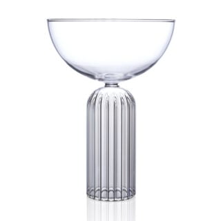 Minimalist studio display of a Fferrone May Coupe in fluted borosilicate glass featuring a smooth clear bowl and a ribbed cylindrical pedestal base | Kneen & Co