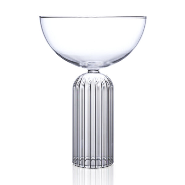 Minimalist studio display of a Fferrone May Coupe in fluted borosilicate glass featuring a smooth clear bowl and a ribbed cylindrical pedestal base | Kneen & Co