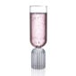 Minimalist studio display of a Fferrone May Flute in fluted borosilicate glass filled with sparkling rosé and featuring a tall smooth bowl on a ribbed cylindrical base | Kneen & Co
