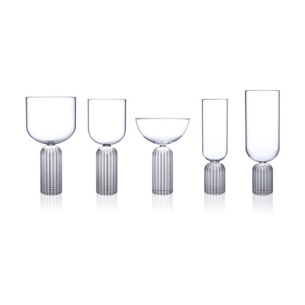 FERRONE-MayGroup-MA-HR-01-Unstyled-1200x1200-100KB Minimalist studio arrangement of Fferrone May Glassware in fluted borosilicate glass featuring an assortment of wine, coupe, and flute glasses with smooth bowls and ribbed bases | Kneen & Co