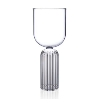 Minimalist studio display of a Fferrone May Medium Glass in fluted borosilicate glass featuring a smooth U-shaped bowl and a ribbed cylindrical pedestal base | Kneen & Co