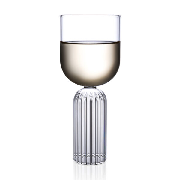 FERRONE-Medium-MAMD02-HR-02-Styled-1200x1200-100KB Minimalist studio display of a Fferrone May Medium Glass in fluted borosilicate glass filled with white wine featuring a smooth U-shaped bowl and a ribbed cylindrical pedestal base | Kneen & Co