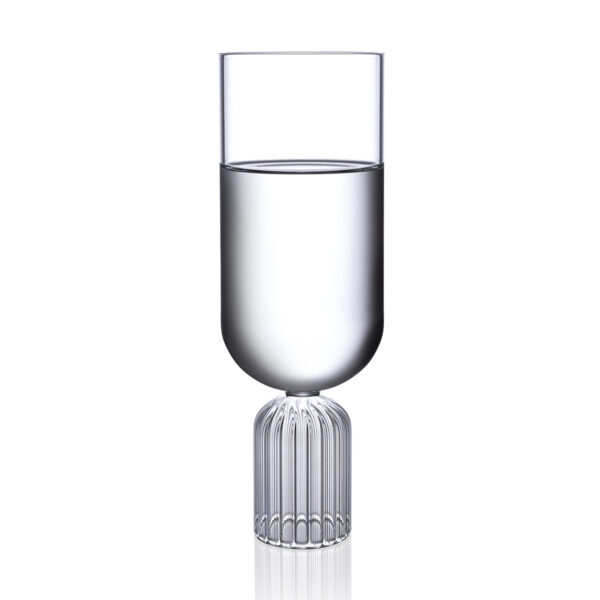 Minimalist studio display of a Fferrone May Tall Medium Glass in fluted borosilicate glass filled with water featuring a tall U-shaped bowl and a ribbed cylindrical pedestal base | Kneen & Co