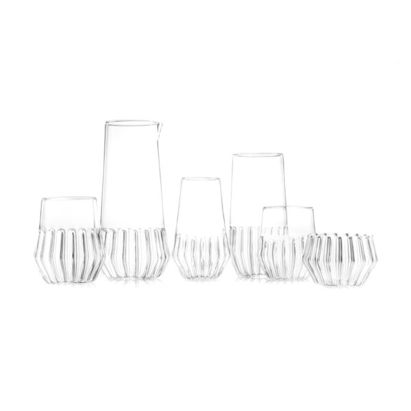 FERRONE-Mixed-LKP-20161229-0103-1200x1200-100KB Minimalist studio arrangement of Fferrone Mixed Glassware in fluted borosilicate glass featuring an assortment of clear tumblers, a pitcher, and a small bowl | Kneen & Co