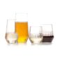 Minimalist studio arrangement of Fferrone Mixed Glassware in fluted borosilicate glass featuring an assortment of tumblers and a tall glass filled with wine and beer | Kneen & Co