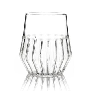 Minimalist studio display of a Fferrone Mixed Medium Glass in fluted borosilicate glass featuring a tapered silhouette and a medium-height ribbed base | Kneen & Co