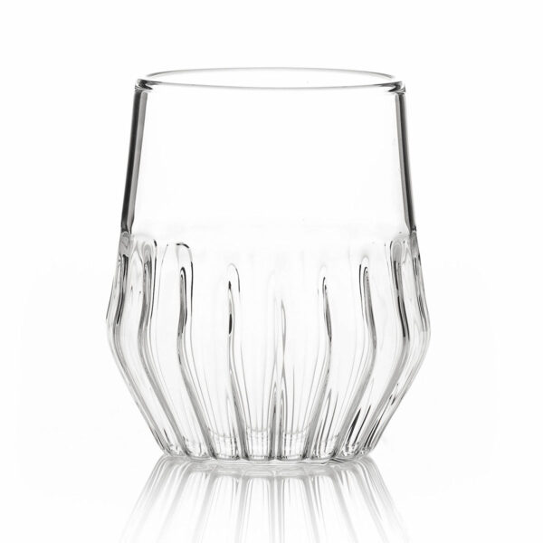 Minimalist studio display of a FFferrone Mixed Small Glass in fluted borosilicate glass featuring a tapered silhouette and a short ribbed base | Kneen & Co