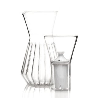 Minimalist studio display of a Fferrone Talise Carafe Fluted in borosilicate glass featuring a tapered carafe and a matching funnel with a white filter insert | Kneen & Co
