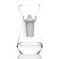 Minimalist studio display of a Fferrone Talise Carafe in clear borosilicate glass featuring a tapered carafe being filled by a matching funnel with a white filter insert |