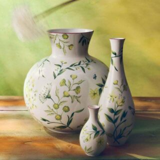 Warmly lit wooden surface with Ginori 1735 Florenza vases in fine porcelain featuring green botanical illustrations and delicate pink rim detailing | Kneen & Co