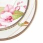 Close-up shot of Wedgwood Hummingbird 2-Tier Cake Stand defined by expressive floral motifs and an artfully sculpted bird finial finished with 22-carat gold detailing | Kneen & Co