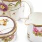 Close-up shot of Wedgwood Hummingbird 3-piece Teaware Set defined by expressive floral motifs and an artfully sculpted bird finial finished with 22-carat gold detailing | Kneen & Co