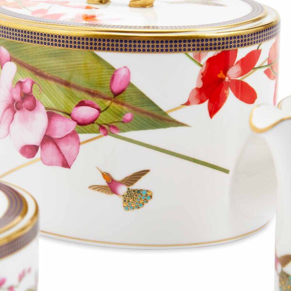 701587439763-Wedgwood-Hummingbird-Teaware-3-Piece-Set-Teapot-Sugar-Cream-detail2-1200x1200-100KB Close-up shot of Wedgwood Hummingbird 3-piece Teaware Set defined by expressive floral motifs and an artfully sculpted bird finial finished with 22-carat gold detailing | Kneen & Co