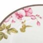 Close-up shot of Wedgwood Hummingbird Dinner Plate defined by expressive floral motifs and an artfully sculpted bird finial finished with 22-carat gold detailing | Kneen & Co