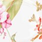 Close-up shot of Wedgwood Hummingbird Salad Plate defined by expressive floral motifs and an artfully sculpted bird finial finished with 22-carat gold detailing | Kneen & Co