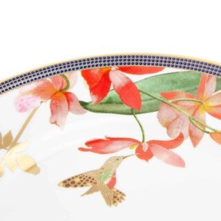 701587439794-Wedgwood-Hummingbird-Plate-20pt6cm-8pt1in-detail2-1200×1200-100KB Close-up shot of Wedgwood Hummingbird Salad Plate defined by expressive floral motifs and an artfully sculpted bird finial finished with 22-carat gold detailing | Kneen & Co