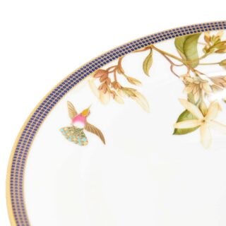 701587439817-Wedgwood-Hummingbird-Rim-Soup-22pt8cm-8pt9in-detail2-1200×1200-100KB Close-up shot of Wedgwood Hummingbird Rim Soup Plate defined by expressive floral motifs and an artfully sculpted bird finial finished with 22-carat gold detailing | Kneen & Co