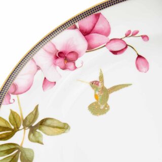 701587439848-Wedgwood-Hummingbird-Oval-Platter-35pt7cm-14in-detail2-1200×1200-100KB Close-up shot of Wedgwood Hummingbird Oval Platter defined by expressive floral motifs and an artfully sculpted bird finial finished with 22-carat gold detailing | Kneen & Co