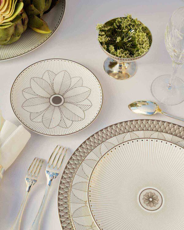 Elegant overhead table setting featuring Christofle Malmaison Impériale porcelain dinnerware | Kneen & Co