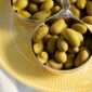 Close-up lifestyle shot of Christofle Malmaison Silver Plated Three-Part Server resting on a Riviera yellow Limoges porcelain plate | Kneen & Co