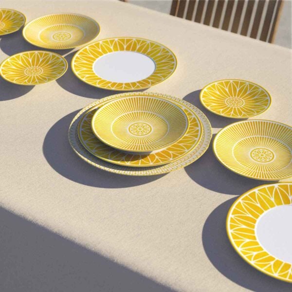 CHRISTOFLE-MALMAISON-RIVIERA-GAMME-2026-RGB-HD-11-1200w-100KB Table set with Christofle Malmaison Riviera plates and bowls in yellow Limoges porcelain featuring hand-drawn geometric and palmette motifs | Kneen & Co